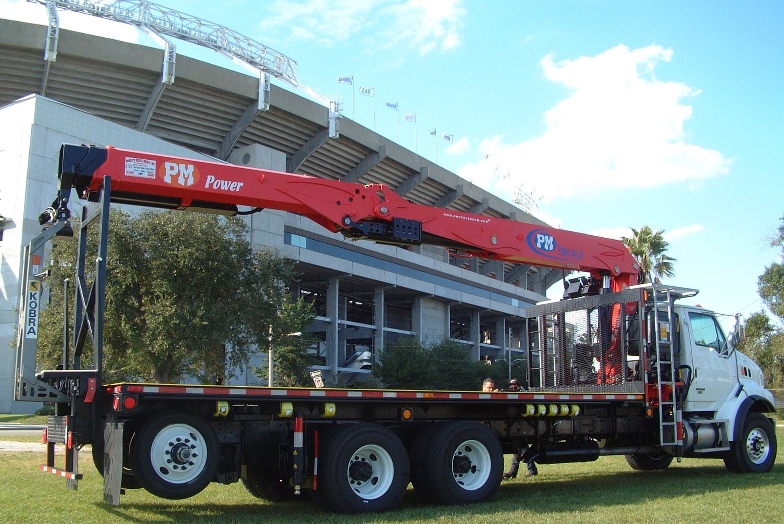 PM 450.22 drywall crane mounted on a tandem axle flatbed truck